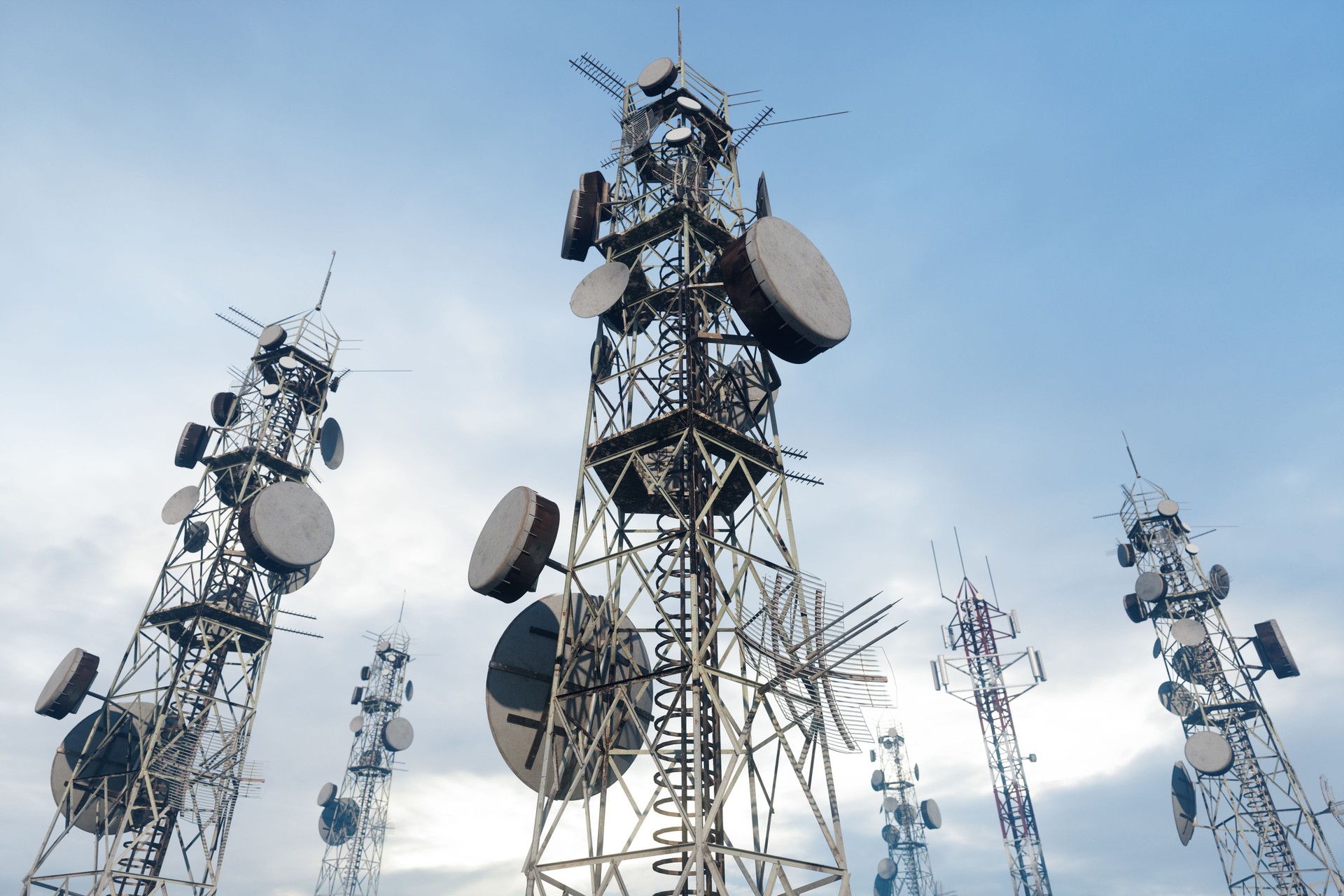 Close-up View Of Antenna Towers With Blue Sky Background